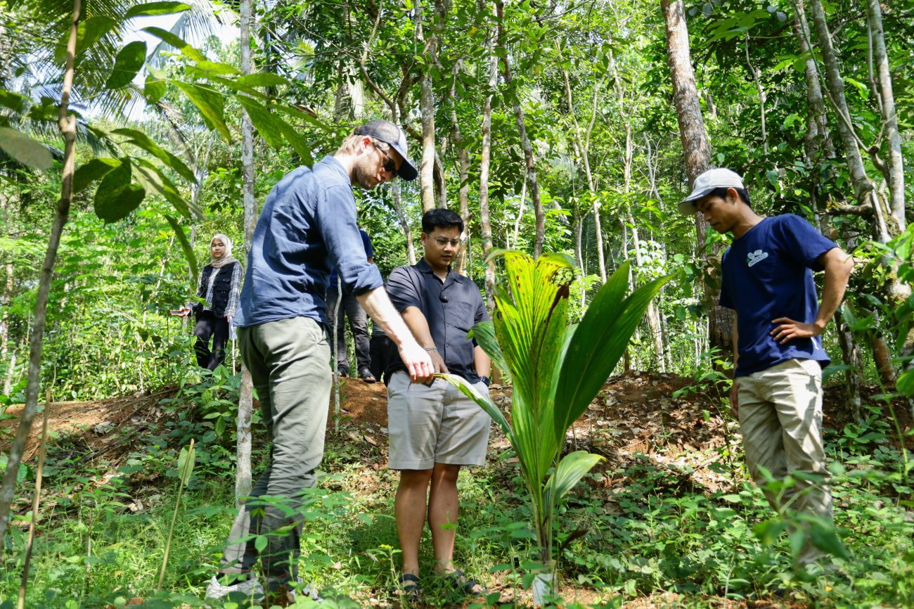 Colleague and our supplier standing next to the seedling